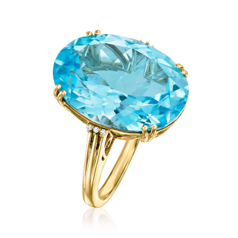 Side view oval sky blue topaz ring in 14kt yellow gold with diamond band details