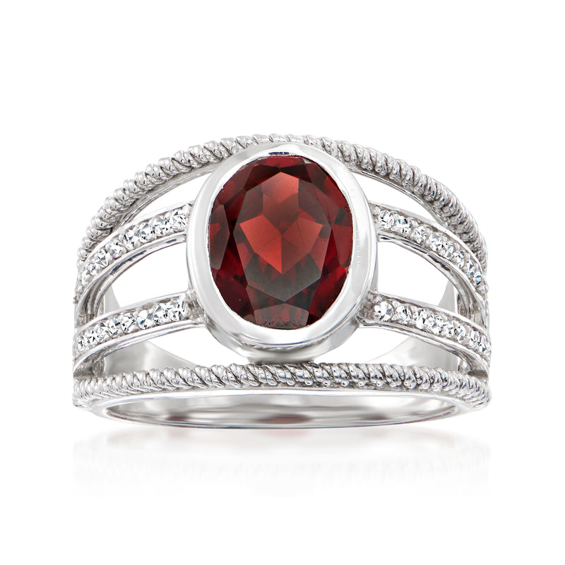 Sterling silver ring with round red garnet center and multi-row diamond accents