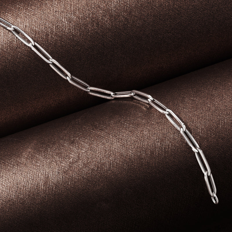 Close-up of 14kt white gold paper clip link bracelet, shiny interlocking links