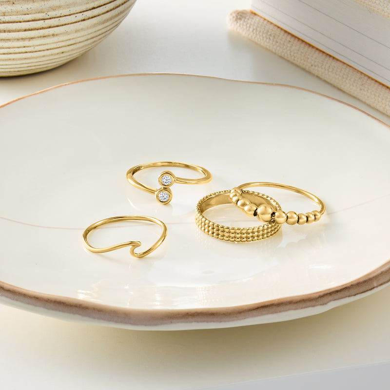 14kt yellow gold wave ring on tray, smooth wavy open band
