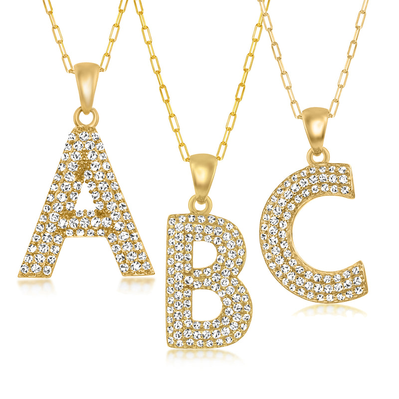 Gold initial pendant necklace with pavé letter charms A, B, and C