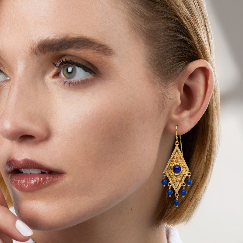 Gold earwire drop earrings with blue oval center stone and dangling beads
