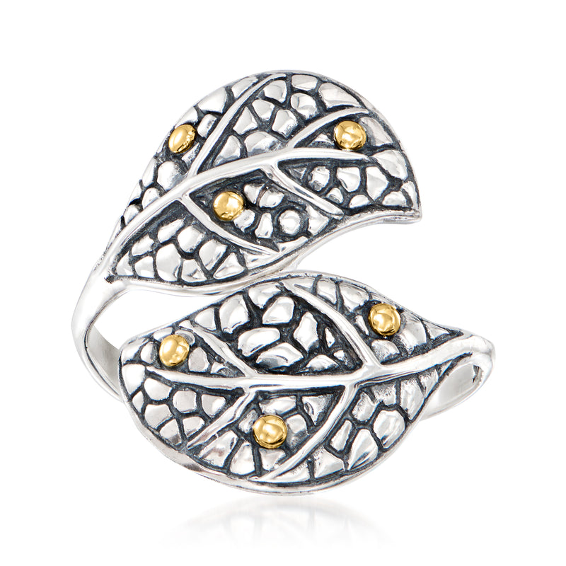 Sterling silver leaf bypass ring with textured vine pattern and small yellow gold accents