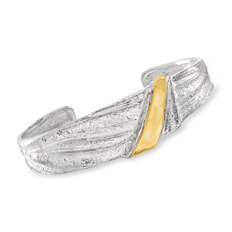 Sterling silver cuff bracelet with raised ridges and yellow gold center stripe