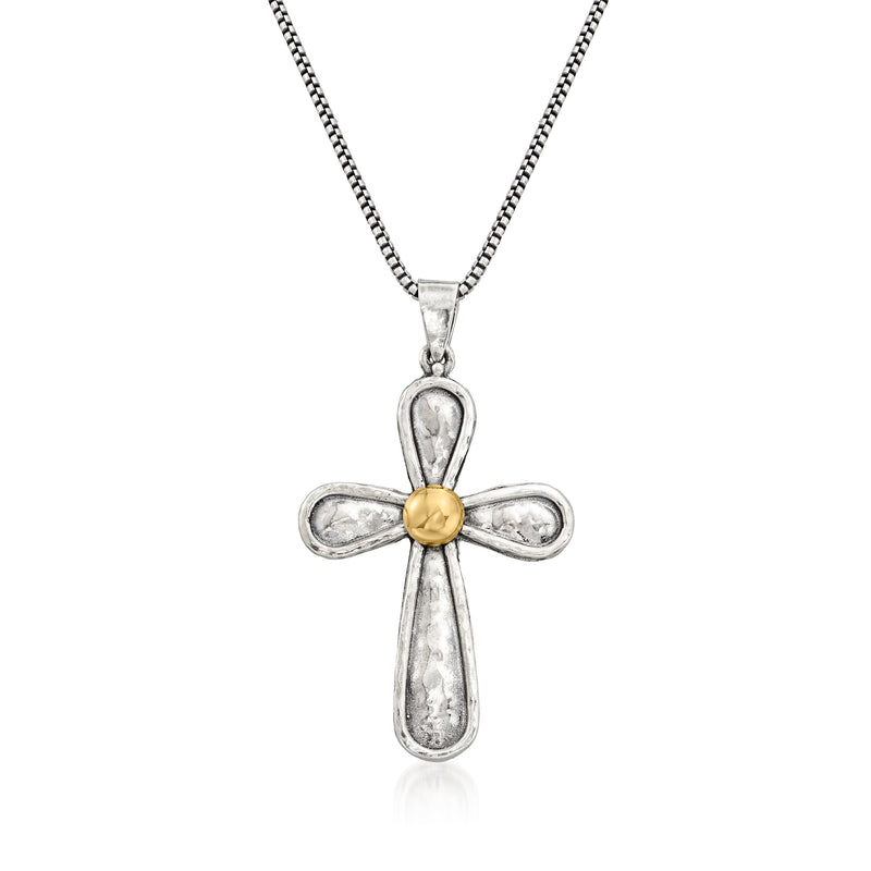 Sterling silver cross pendant with yellow gold center on a chain