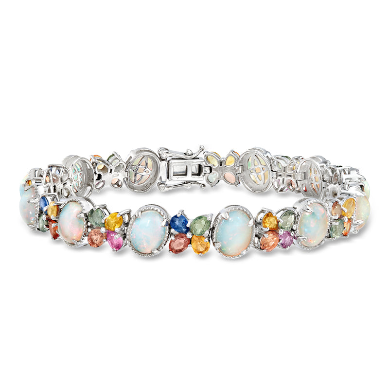Sterling silver multicolor gemstone bracelet with round opal-like stones and sapphire accents.