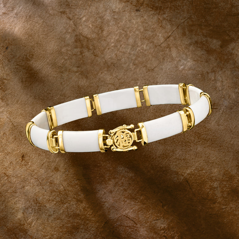 White agate bracelet with gold over sterling, round relief charm at center, hinged segments
