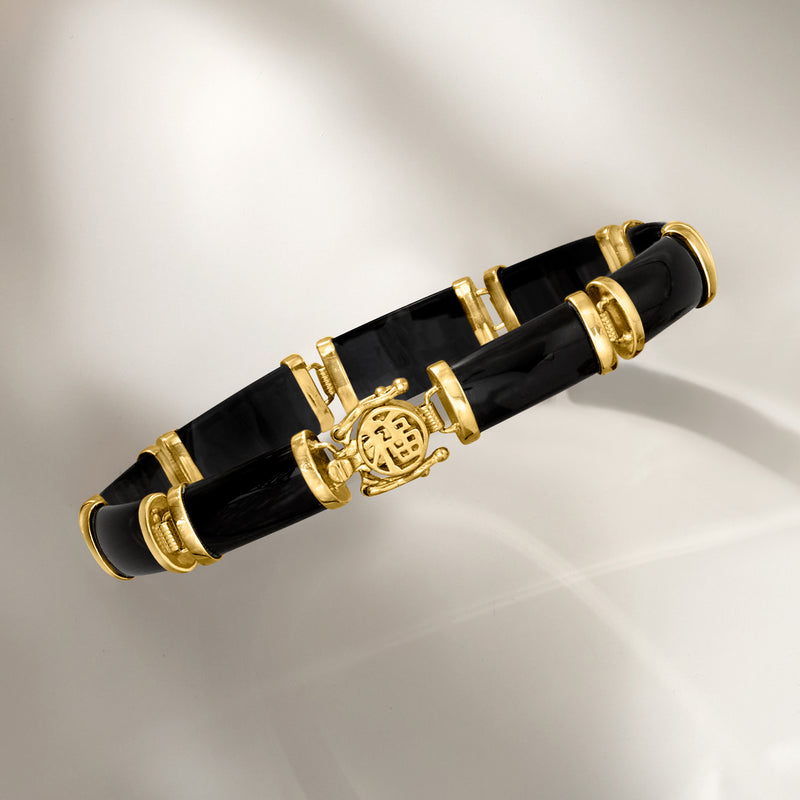 Black agate bracelet featuring gold-tone clasp and circular fortune medallion detail.
