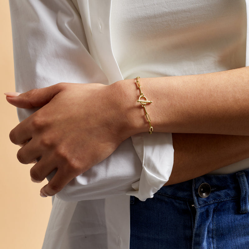 14kt yellow gold paper clip link toggle bracelet worn on wrist