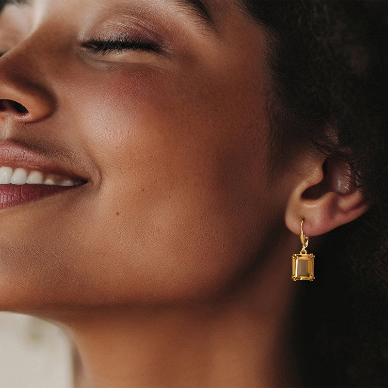 Square citrine drop earrings on gold leverback, shown on ear.