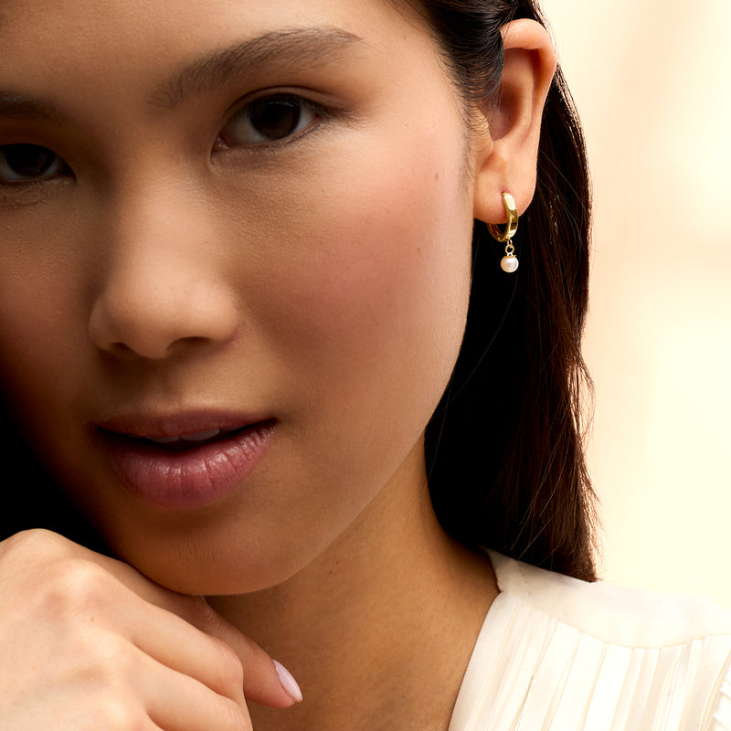 Cultured pearl huggie hoop earring in 14kt yellow gold with pearl charm