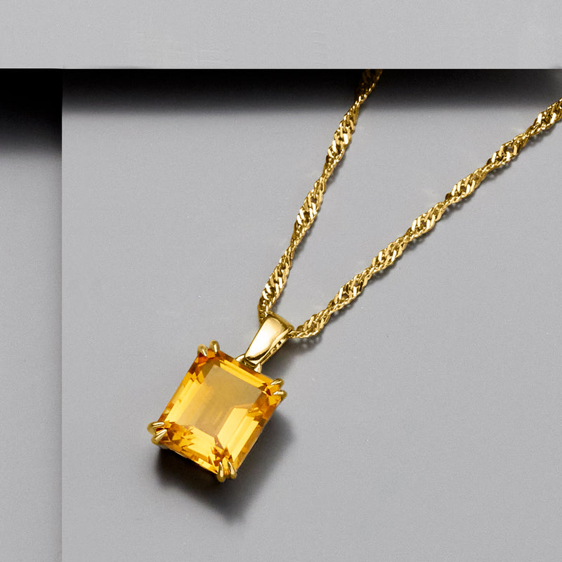 Gold-tone necklace with square citrine gemstone pendant on rope chain