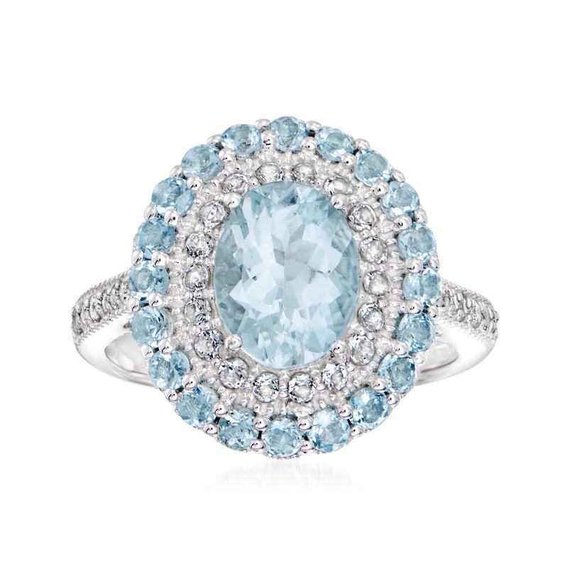 Sterling silver ring with oval aquamarine center and blue gemstone halo, prong-set
