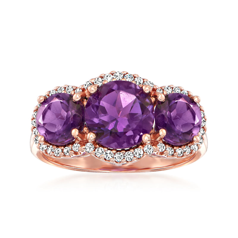 Amethyst and diamond halo ring in 14kt rose gold with three purple gemstones