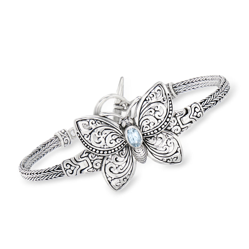Sterling silver butterfly bracelet with engraved wings and sky blue gemstone center