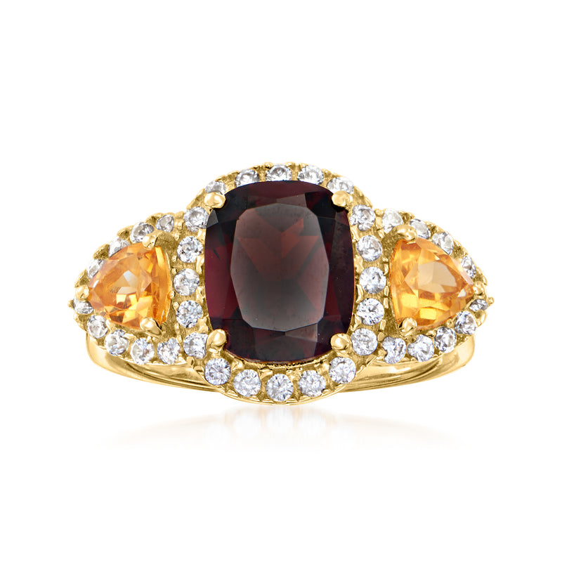 Garnet ring with oval citrine side stones, white zircon halo, gold-tone setting
