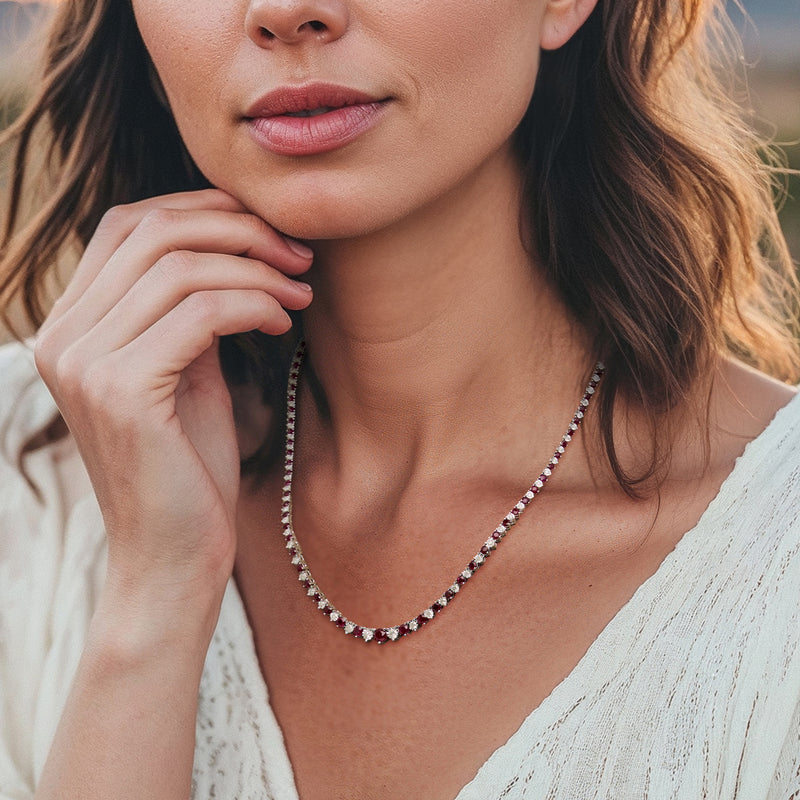 Sterling silver ruby and diamond tennis necklace worn on the neckline, close-up
