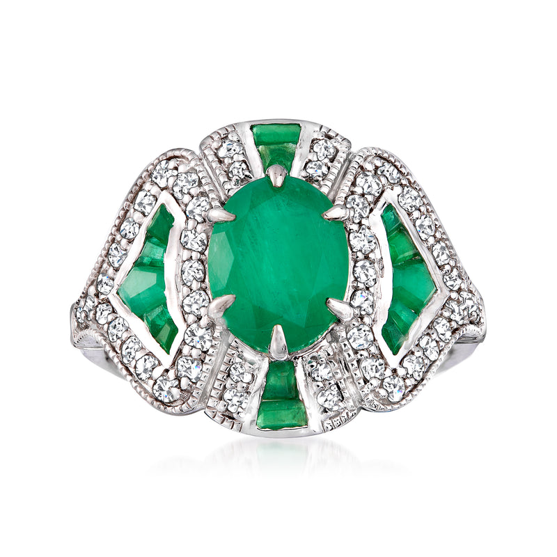 Emerald and diamond ring with oval green center stone in white gold, halo prongs