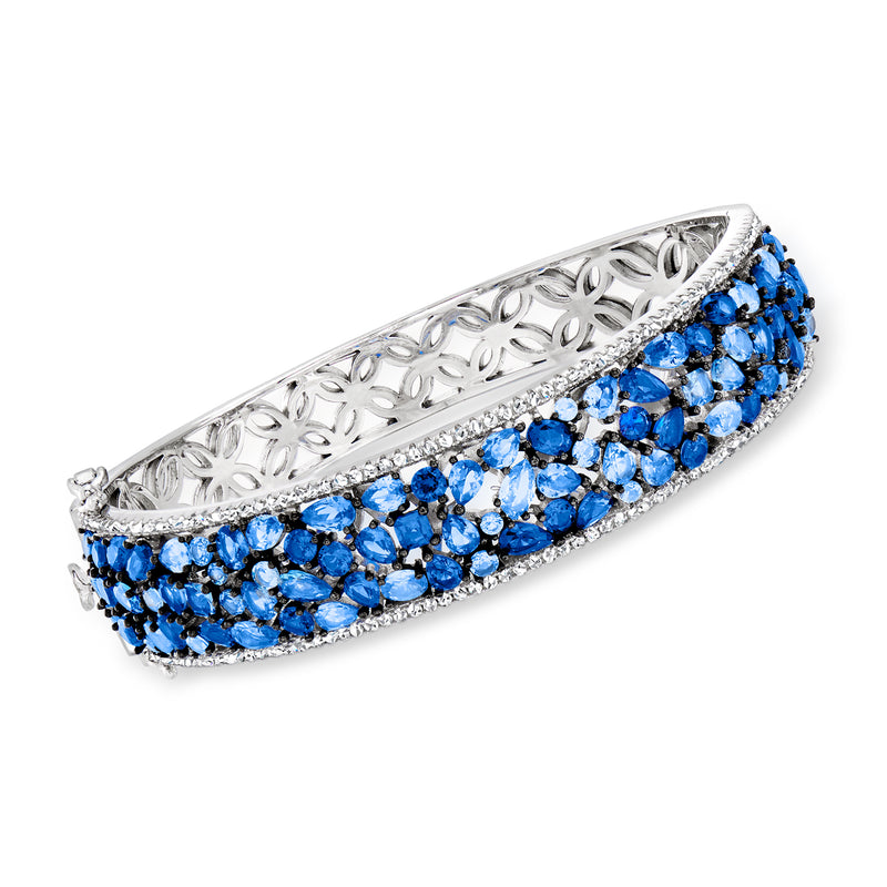 Sterling silver bangle bracelet with openwork blue simulated sapphire and CZ stones