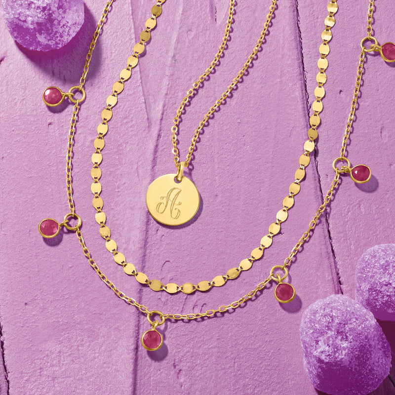 Layered yellow gold mirror-link necklaces with small circular links and red heart charms