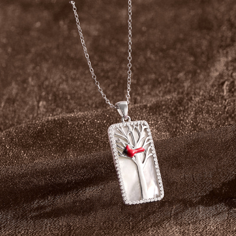 Sterling silver cardinal pendant with red enamel bird, tree motif, and crystal border