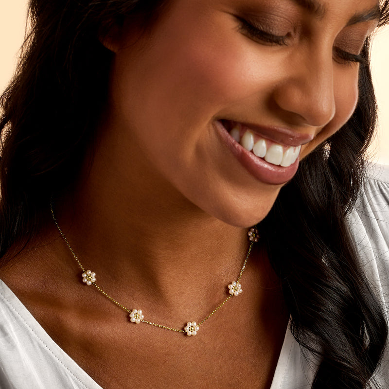 14kt yellow gold pearl flower station necklace, close-up on model