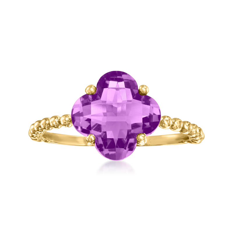 Amethyst flower ring in 14kt yellow gold, oval purple gem with four prong petals.