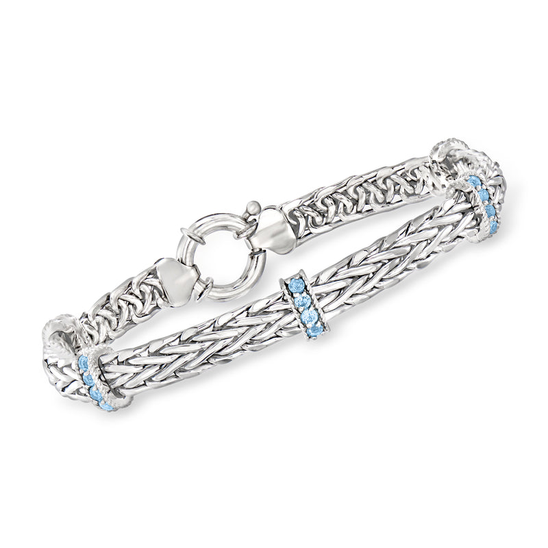 Sterling silver wheat chain bracelet with blue topaz station stones and toggle clasp