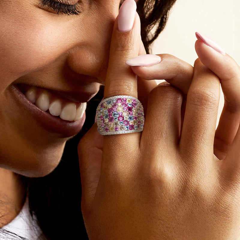 Sterling silver wide ring with multicolored stones on a model's finger