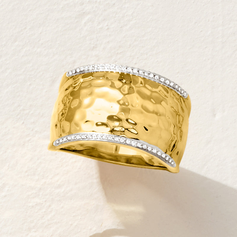 Hammered gold ring with pavé-style diamond rows along the top and bottom edges