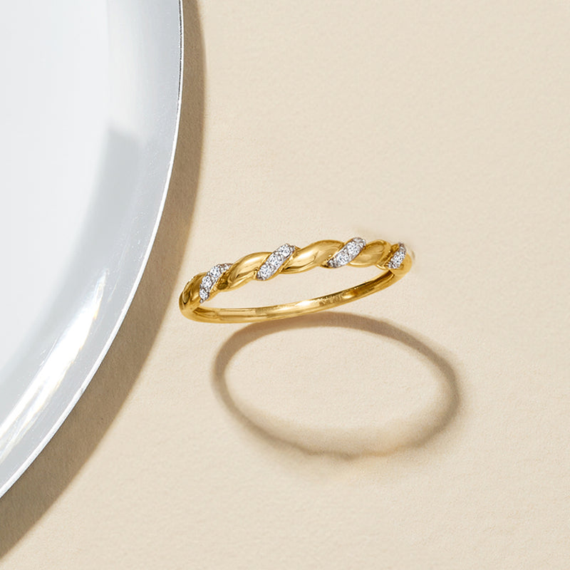 Thin 14kt yellow gold twisted diamond band ring, seen from side angle