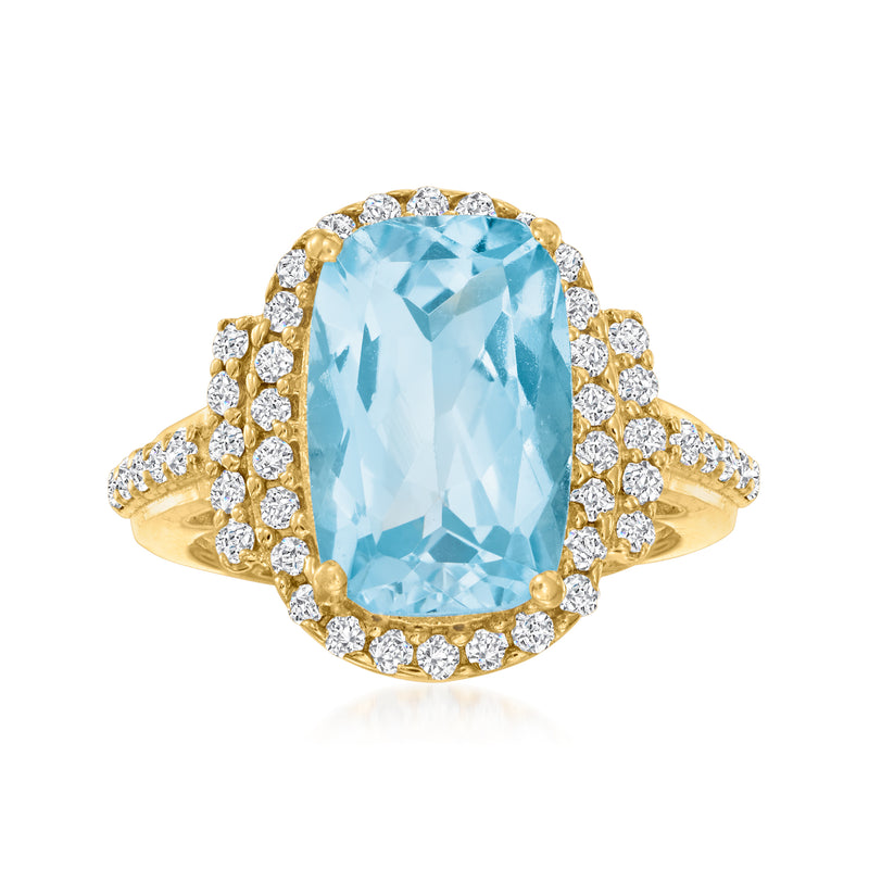 Sky blue topaz oval ring in gold with diamond halo and side diamonds