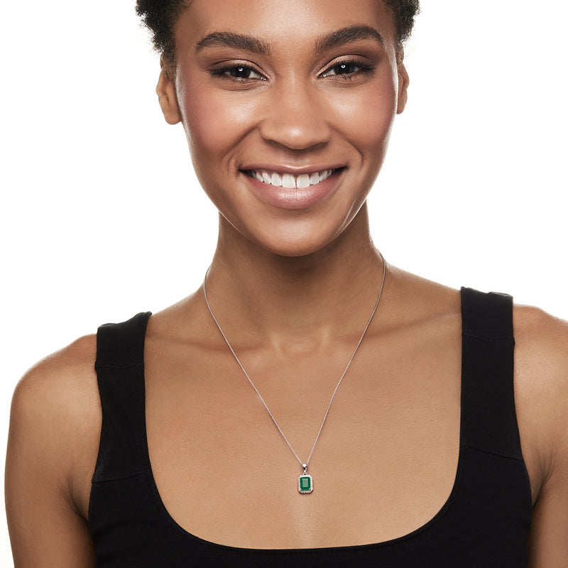 White gold chain necklace with rectangular emerald pendant and diamond halo