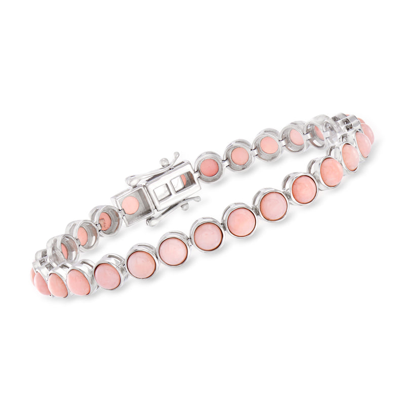 Sterling silver tennis bracelet with round pink opal-like stones and link clasp