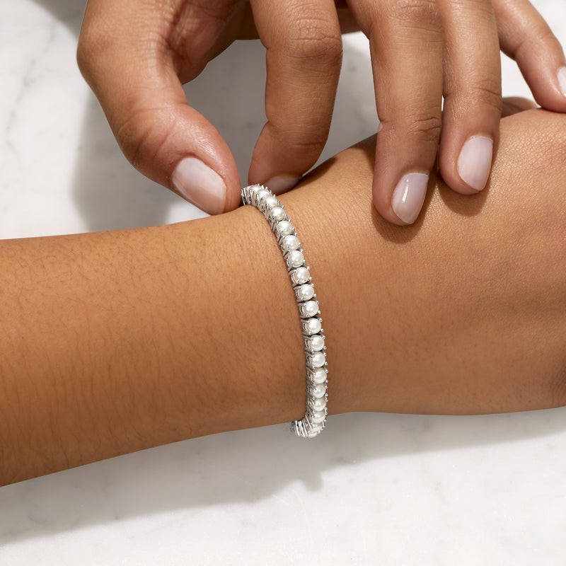 Sterling silver cultured pearl tennis bracelet close-up with white pearls and pave links