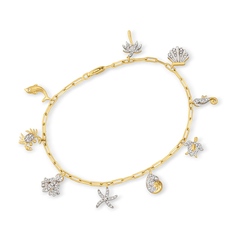Gold-tone link bracelet with sparkle sea-life charms: starfish, turtle, shell, fish