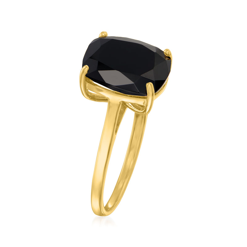 Gold tone ring with large oval black gemstone set in four prongs, slender band