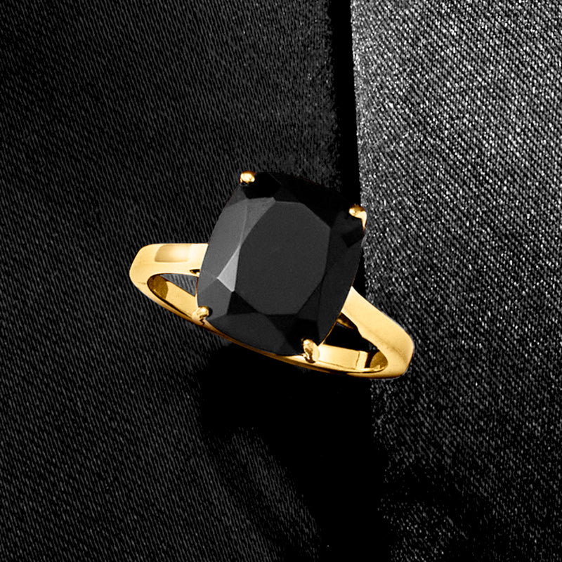 Gold over sterling ring with faceted black oval onyx and four small gold prongs