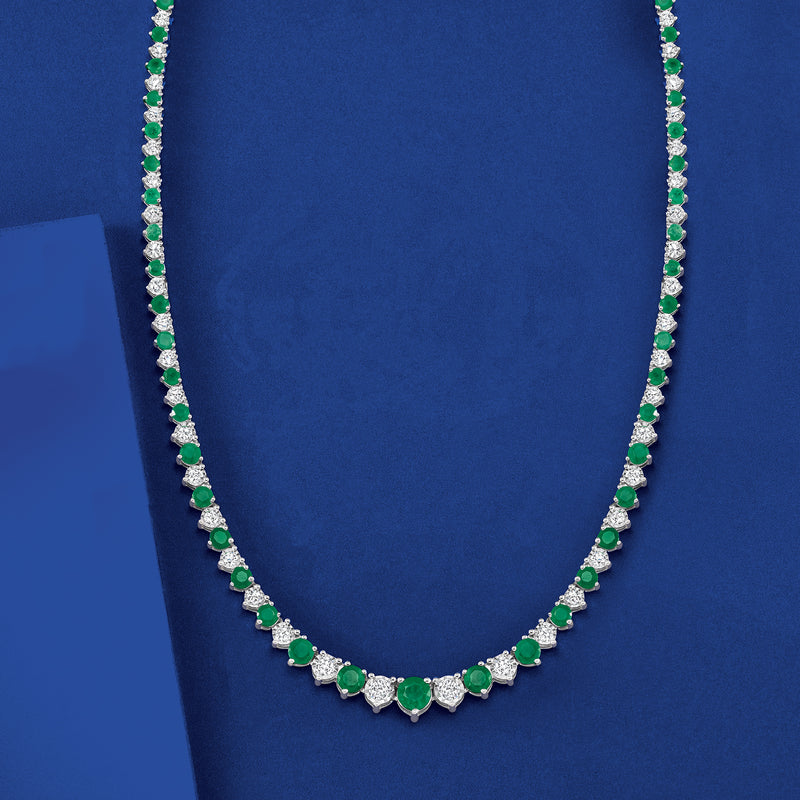 Sterling silver tennis necklace featuring alternating green emerald and white diamond drops
