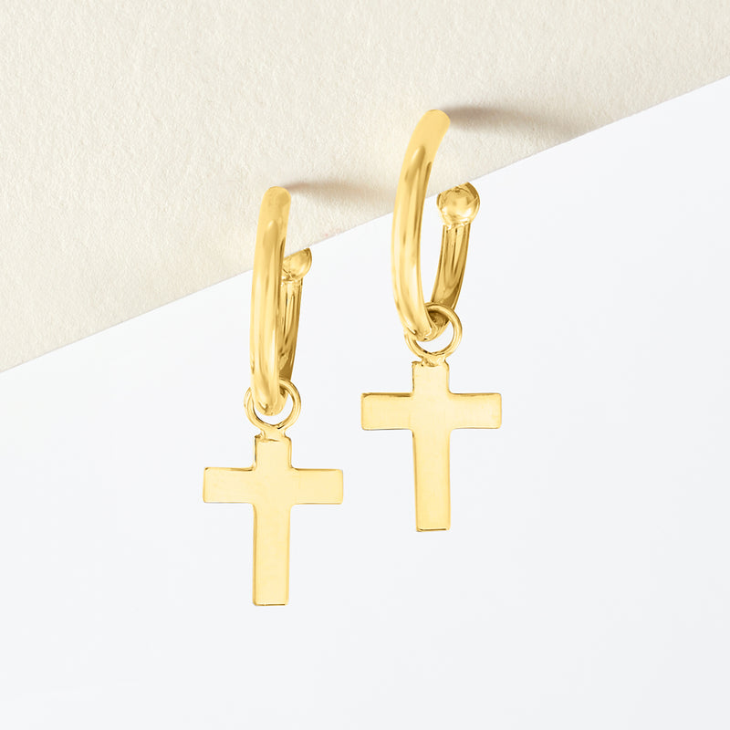 14kt yellow gold hoop drop earrings with cross charms, angled on ear