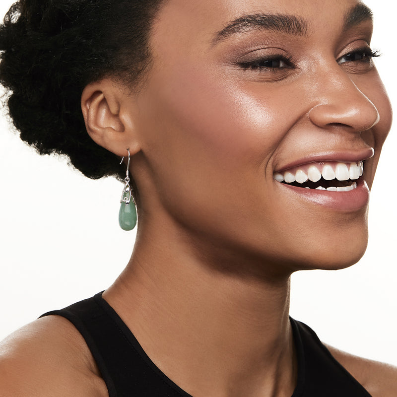 Jade teardrop drop earring on model, sterling silver earwire with green stone