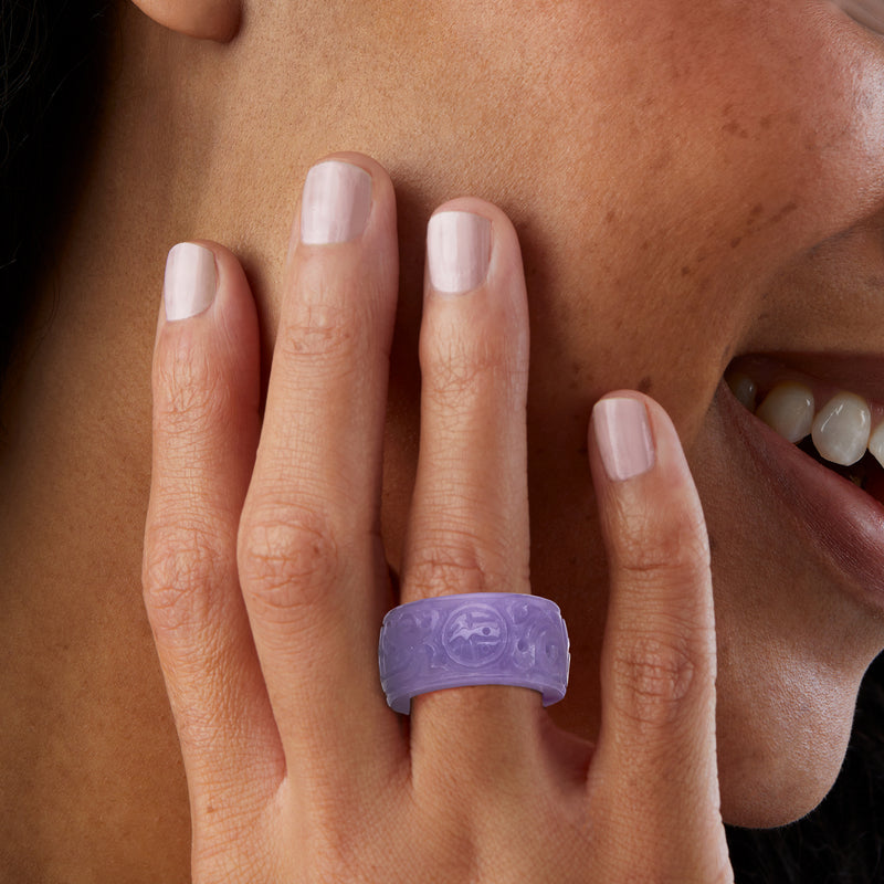 Lavender jade fortune ring on hand with short manicured nails