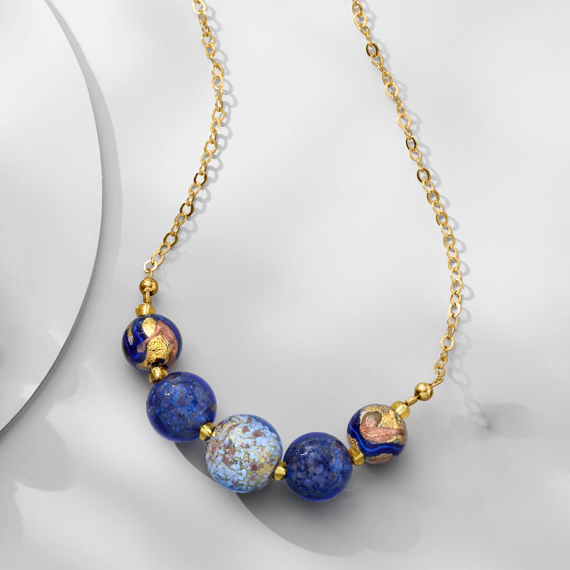 Gold-tone necklace with blue Murano glass beads and gold-accented details on linked chain