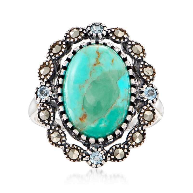 Turquoise oval gemstone ring with ornate marquise and round halo accents, silver-tone setting