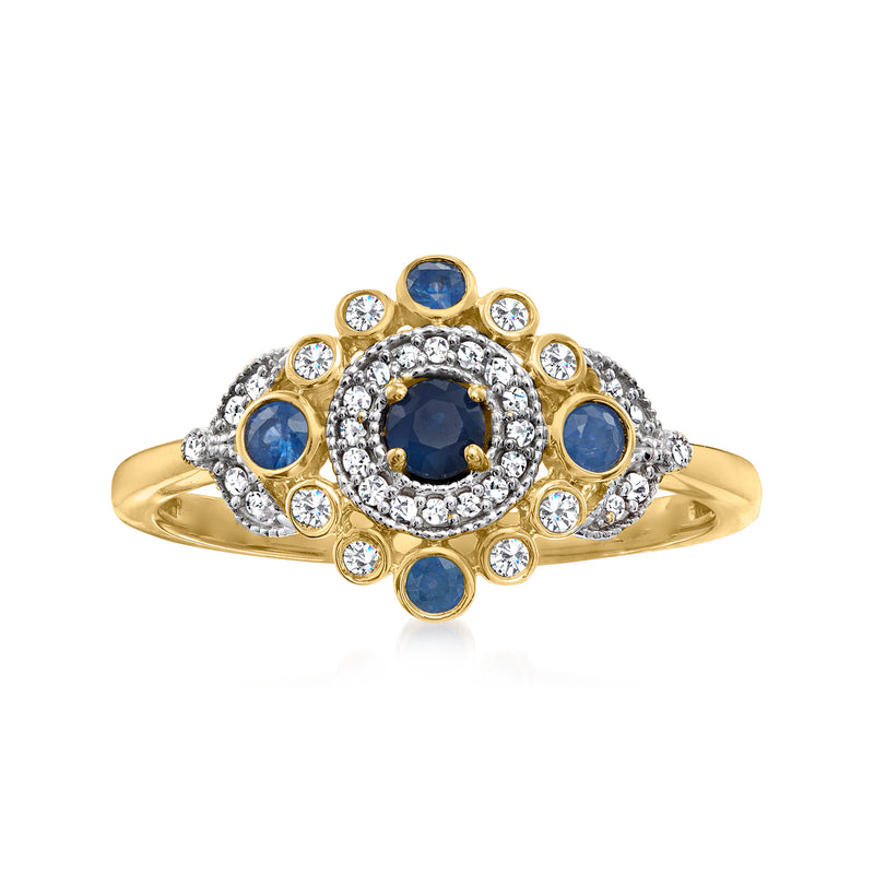 14kt yellow gold ring with round blue sapphire center and diamond halo and side stones