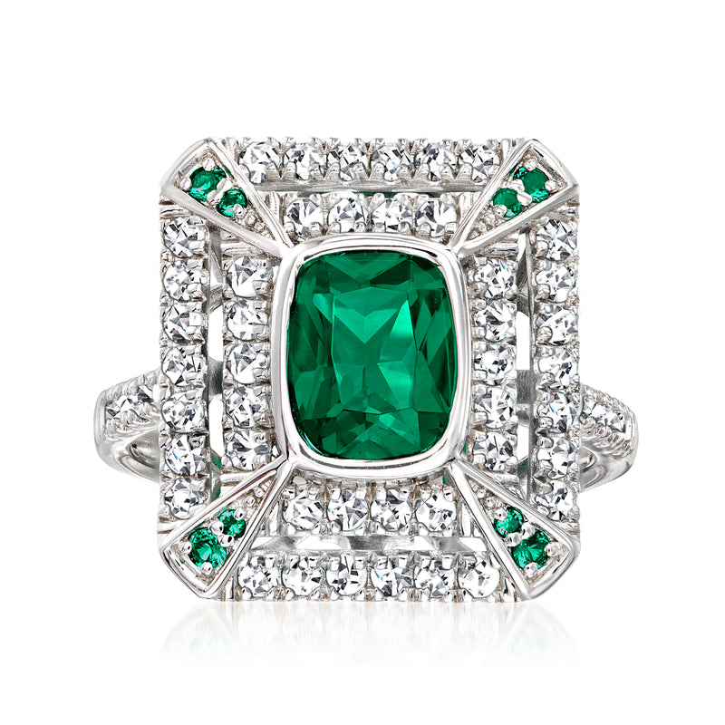 Sterling silver ring with emerald-green center stone, CZ halo, and small green accents