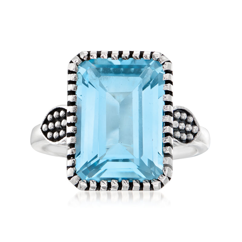 Sterling silver ring with large sky blue topaz, emerald-cut center, bead-set sides