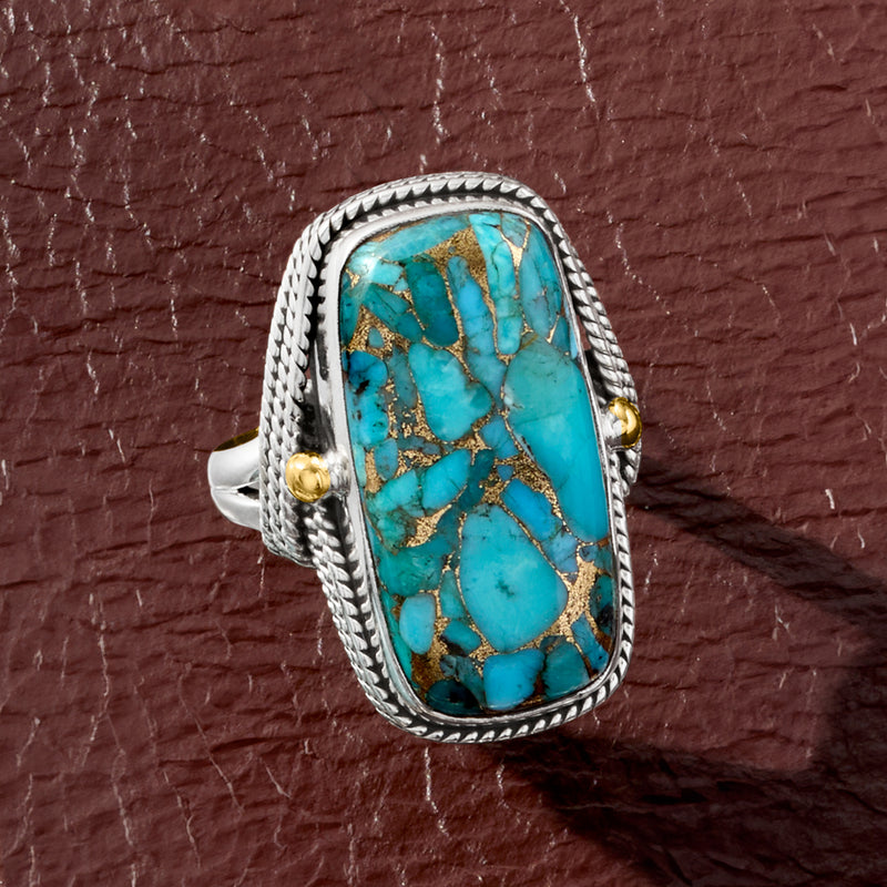 Sterling silver turquoise oval ring with rope-edge frame and gold-toned side accents