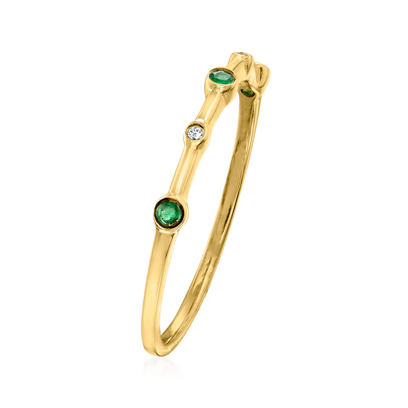 14kt yellow gold ring side view with two green emerald stones and one diamond detail