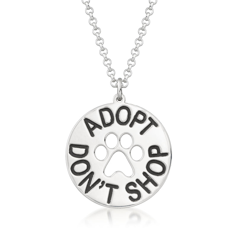 Silver round pendant necklace with paw print and “ADOPT DON’T SHOP” lettering